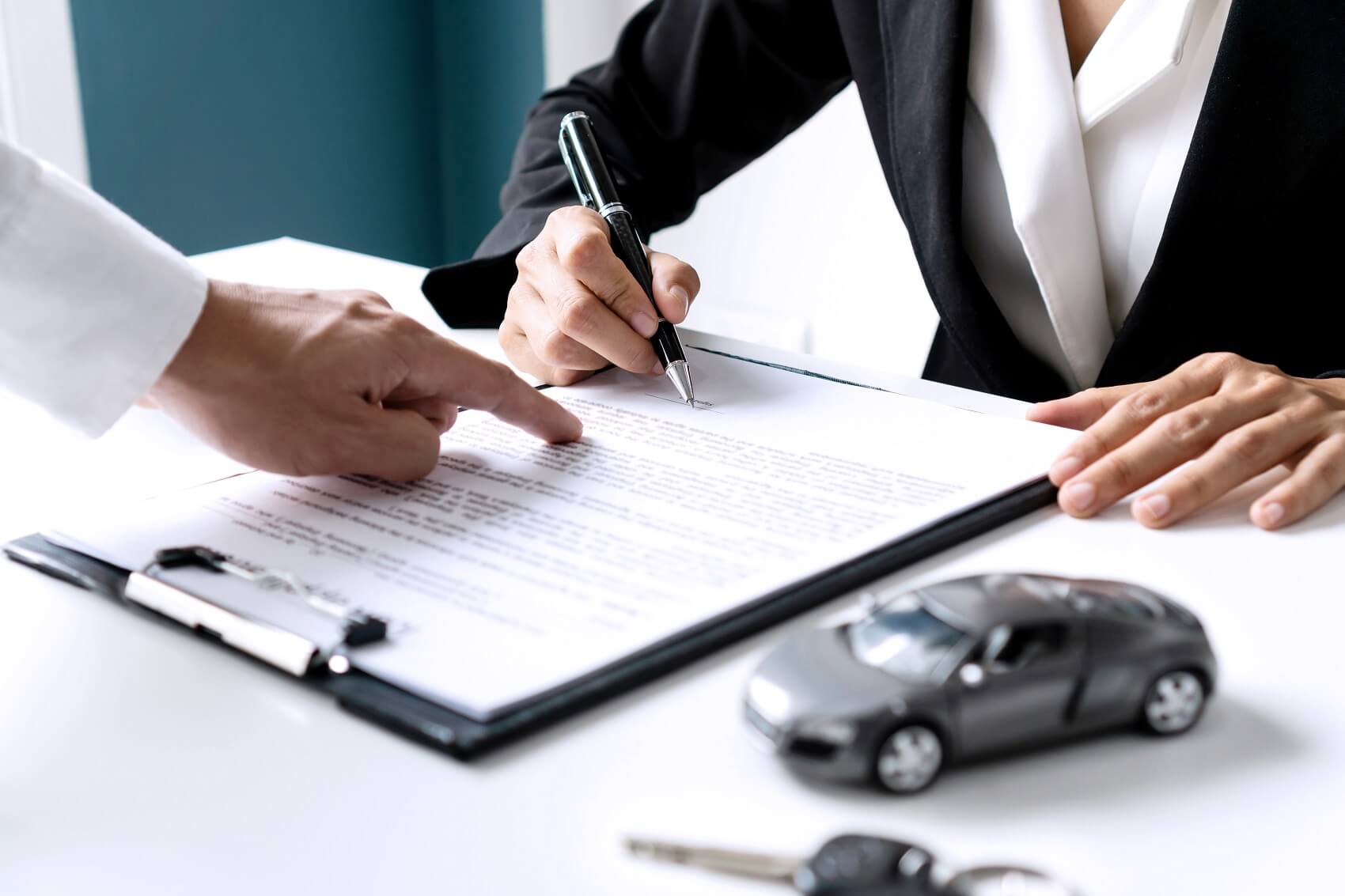 Close up of customer signing financing paperwork